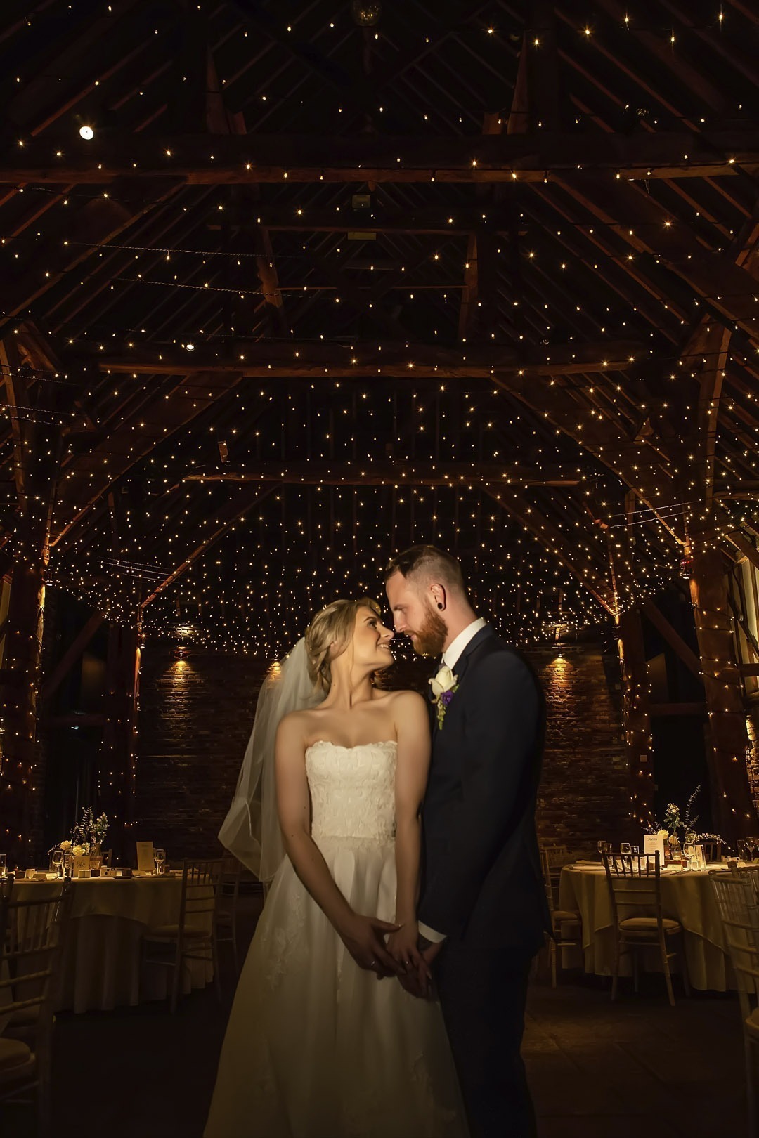 Bride and groom looking lovely into each other's eyes at Cooling Castle Barns